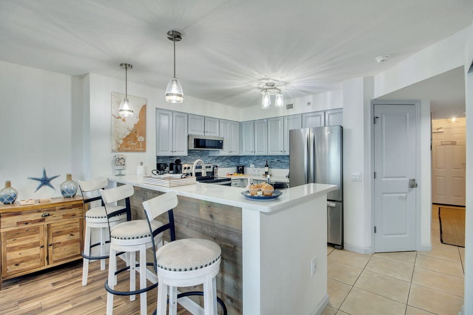Your fully equipped kitchen awaits with coastal touches, granite counters, and everything you need to create memorable meals during your stay.
