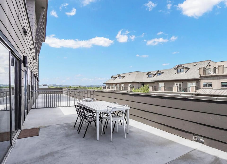 Large patio with dining table and view