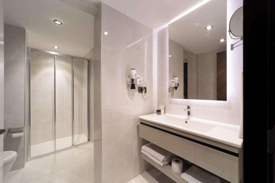 Shower, designer toiletries, hair dryer, slippers