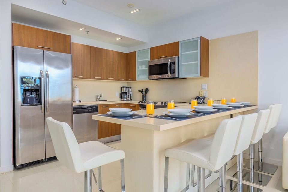 Your sleek kitchen features modern appliances, generous counter space, and stylish bar seating—perfect for preparing meals and casual dining.