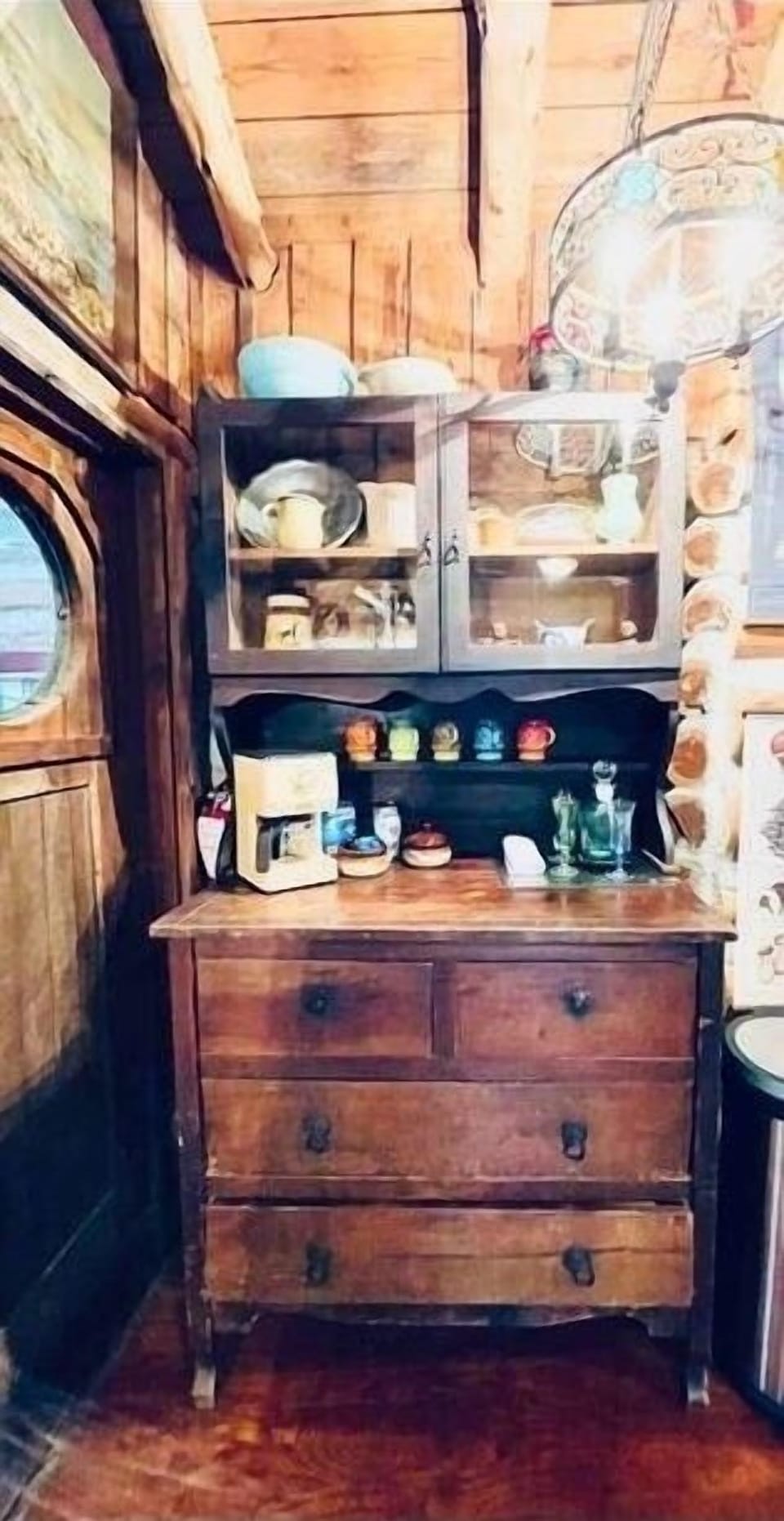 Eclectic coffee station stocked with silverware, utensils, and vintage coffee cups and glasses. Ever