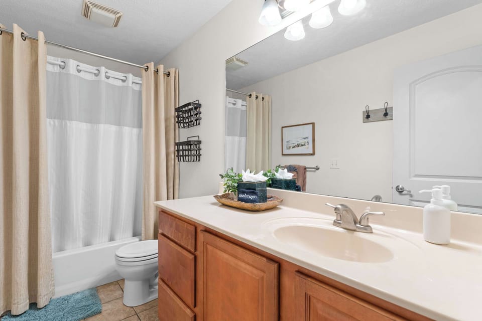 The main bathroom is situated right off the living room and next to Bedroom 1 and 2