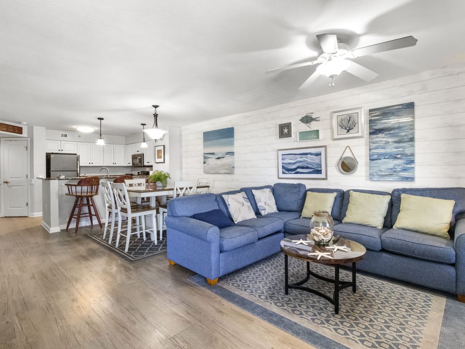 Unwind in your spacious coastal retreat with comfortable seating, ocean-themed décor, and an open kitchen perfect for family gatherings.