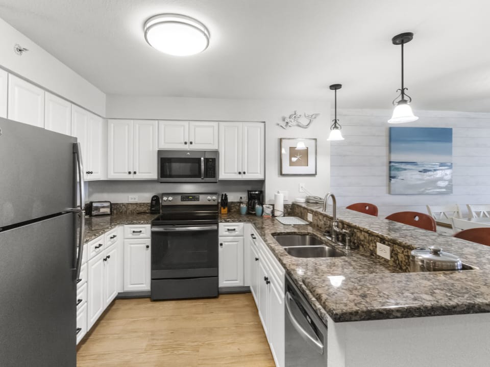 Cook with confidence in your spacious kitchen featuring granite counters, full appliances, and a breakfast bar perfect for morning coffee.