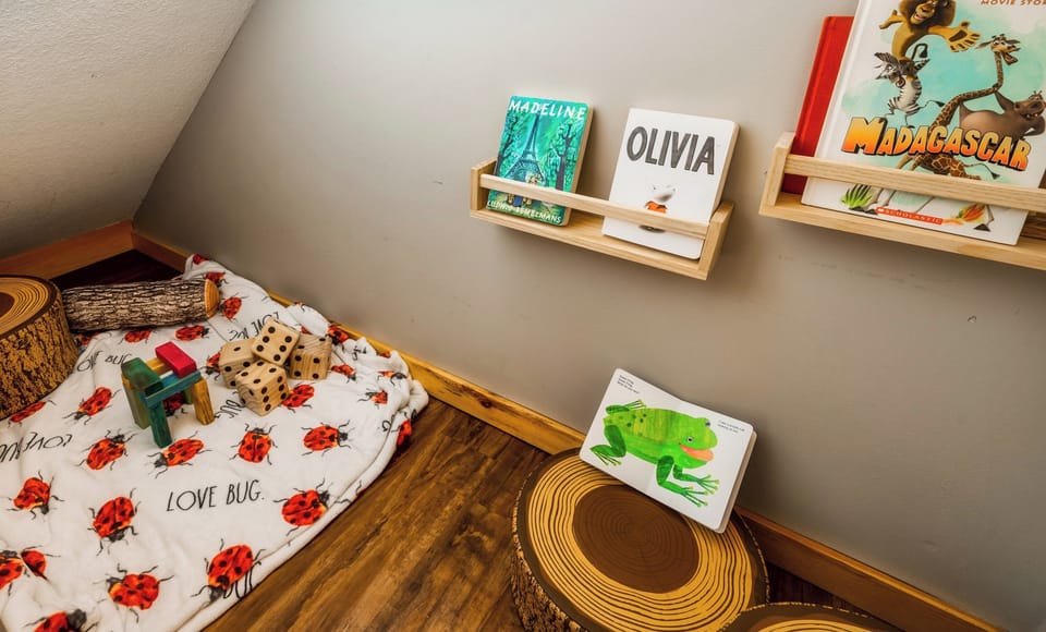 Nestled under the stairs, our delightful children’s nook provides a special corner for young adventurers to explore. This charming space is tailored for play and creativity, inviting little ones into a world of imagination, fun, and wonder.