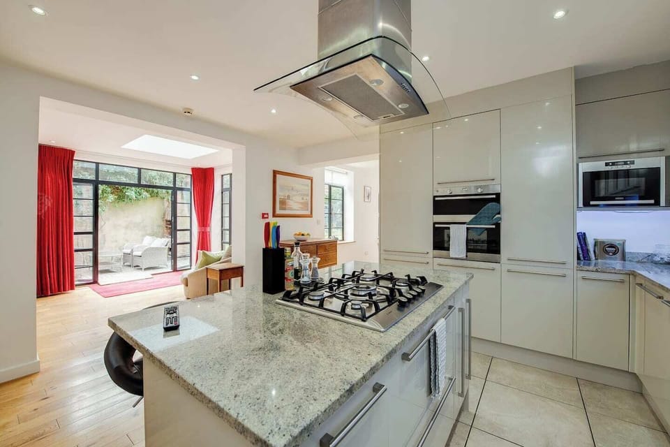 Kitchen: Stylish space with modern appliances and inviting views of the serene garden!
