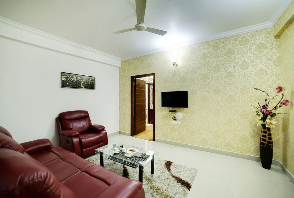 Suite, 1 King Bed, City View | Living area | 32-inch LED TV with satellite channels, TV