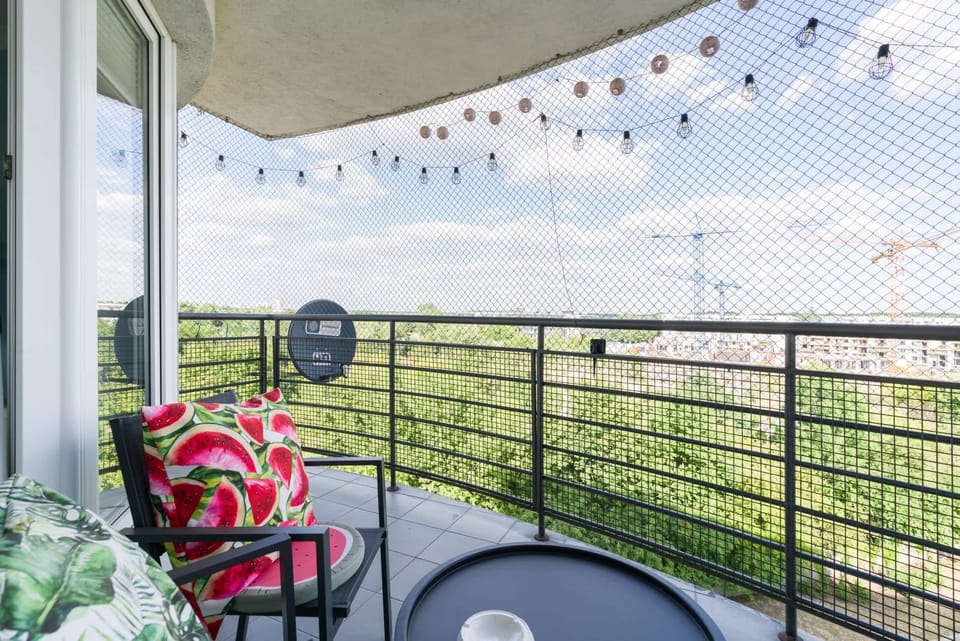The furnished balcony offers a perfect spot for morning coffee with a view.
