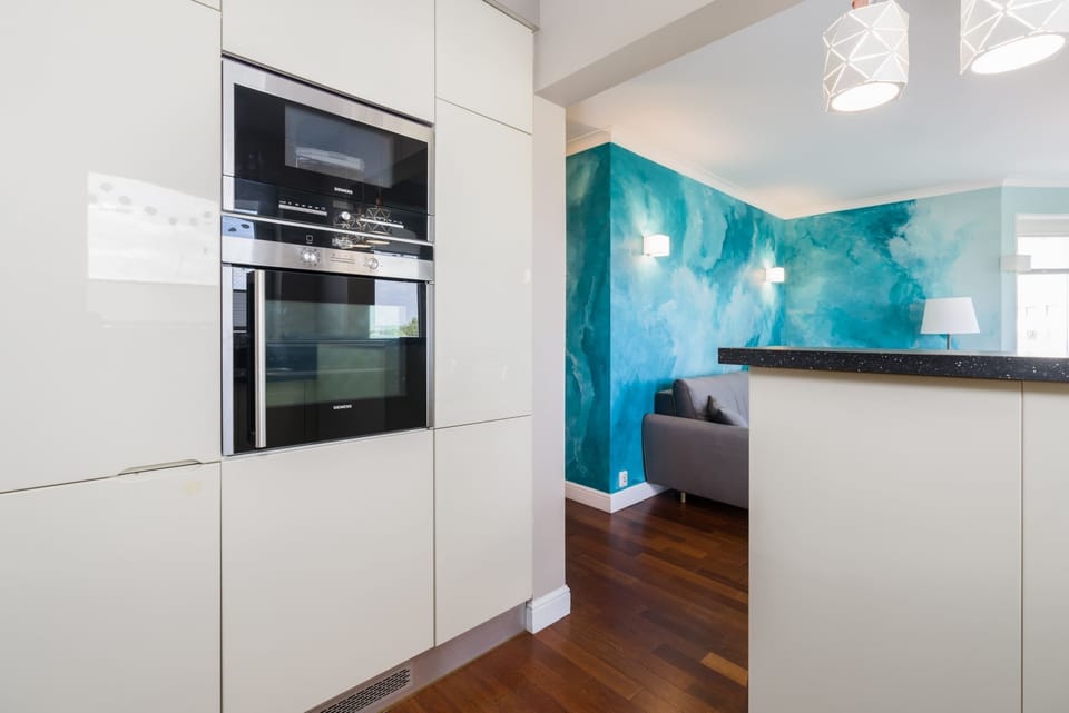The sleek design of the kitchenette blending seamlessly with the living area.