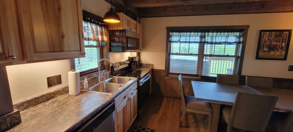 Kitchen complete with full sink, microwave, stove and dining table for 6