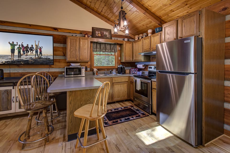 Full kitchen stocked with utensils, cookware, and coffee bar.