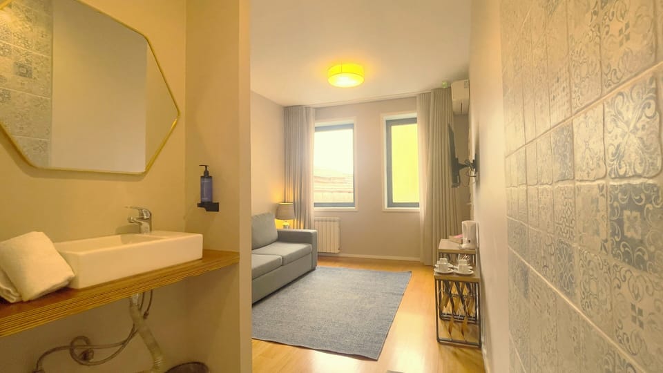 Family Quadruple Room | Living area | Flat-screen TV