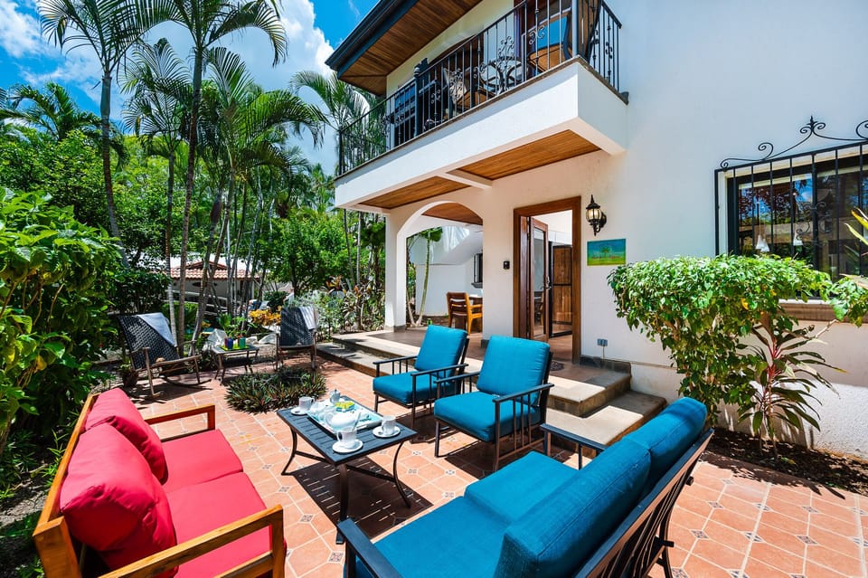 Relax in the amazing outdoor living space featuring comfortable hanging seats—perfect for enjoying the tropical breeze, sunsets, and a family vacation near Tamarindo Beach.