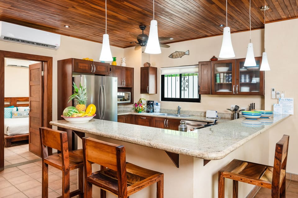 Fully equipped kitchen with a sleek counter, modern appliances, and all the essentials to prepare delicious meals during your Tamarindo Beach vacation.