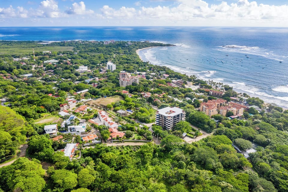 Breathtaking aerial view of Tamarindo town and beach, with Langosta Beach in the background, surrounded by the lush Las Baulas National Park. Ideal location for exploring Costa Rica’s pristine coastline, surf spots, and family-friendly activities.