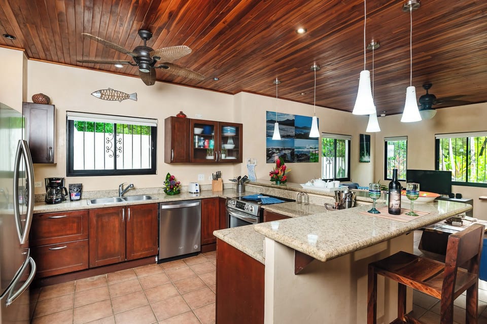Spacious Kitchen, Bright and functional kitchen featuring a stylish counter, high-quality appliances, and plenty of space to cook for family and friends at your Tamarindo Beach rental.