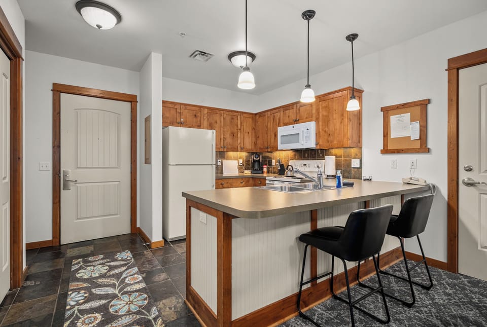 Bright rustic kitchen with island seating and warm wood finishes