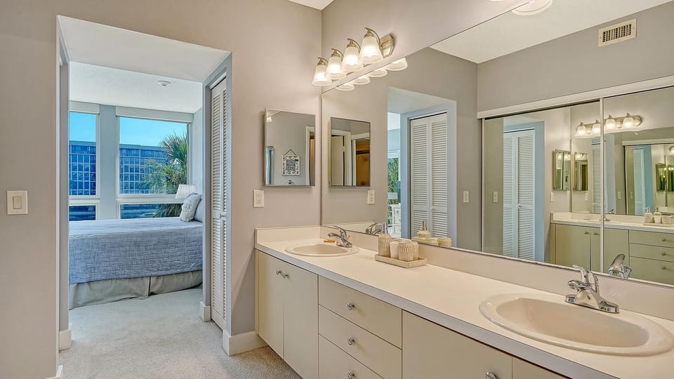 Bright, spacious bathroom with dual sinks and natural light