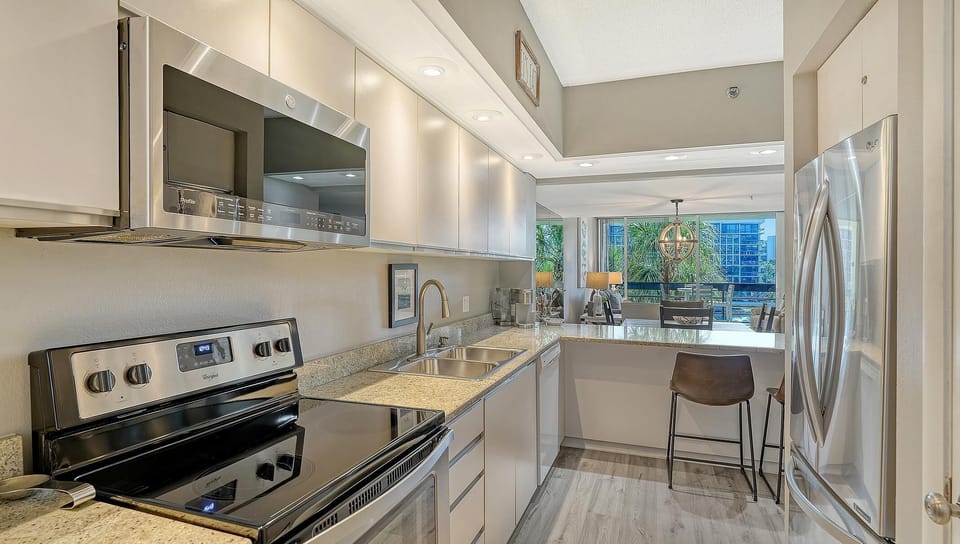 Sleek modern kitchen with stainless steel appliances and breakfast bar