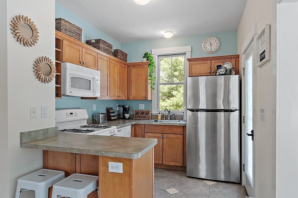 Well-stocked kitchen with microwave and dishwasher.