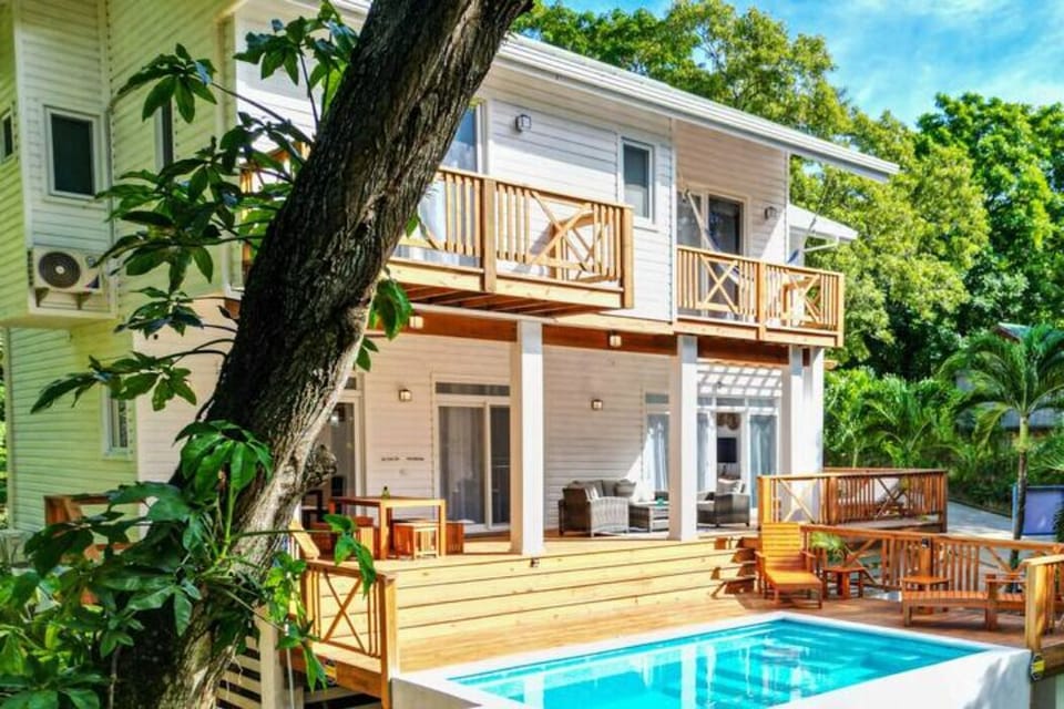 Home is surrounded by gardens and a 4-min walk to WB Beach.  
