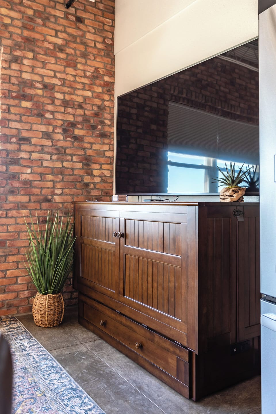 Murphy bed for additional sleeping options. (Looks like a tv console)