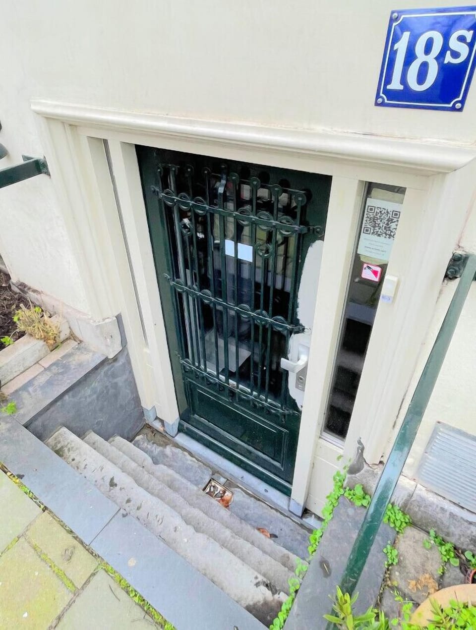 The entry is four steps down from the sidewalk