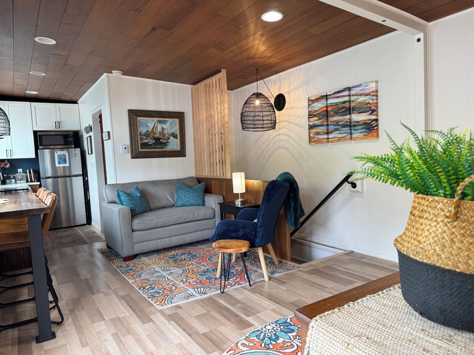 Main floor living space with loveseat that pulls out to a twin sleeper 