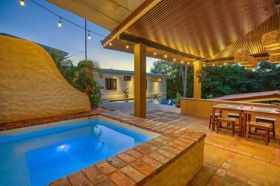 Unwind in this enchanting outdoor space, perfect for evening relaxation. Take a dip in the inviting hot tub, dine al fresco under the charming string lights, and soak in the tranquil ambiance. With comfortable seating and beautiful surroundings, this area is ideal for creating unforgettable memories with family and friends.