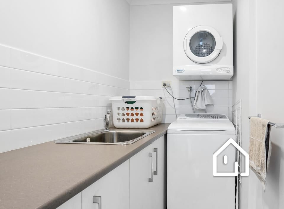 Laundry with top loader washing machine and dryer