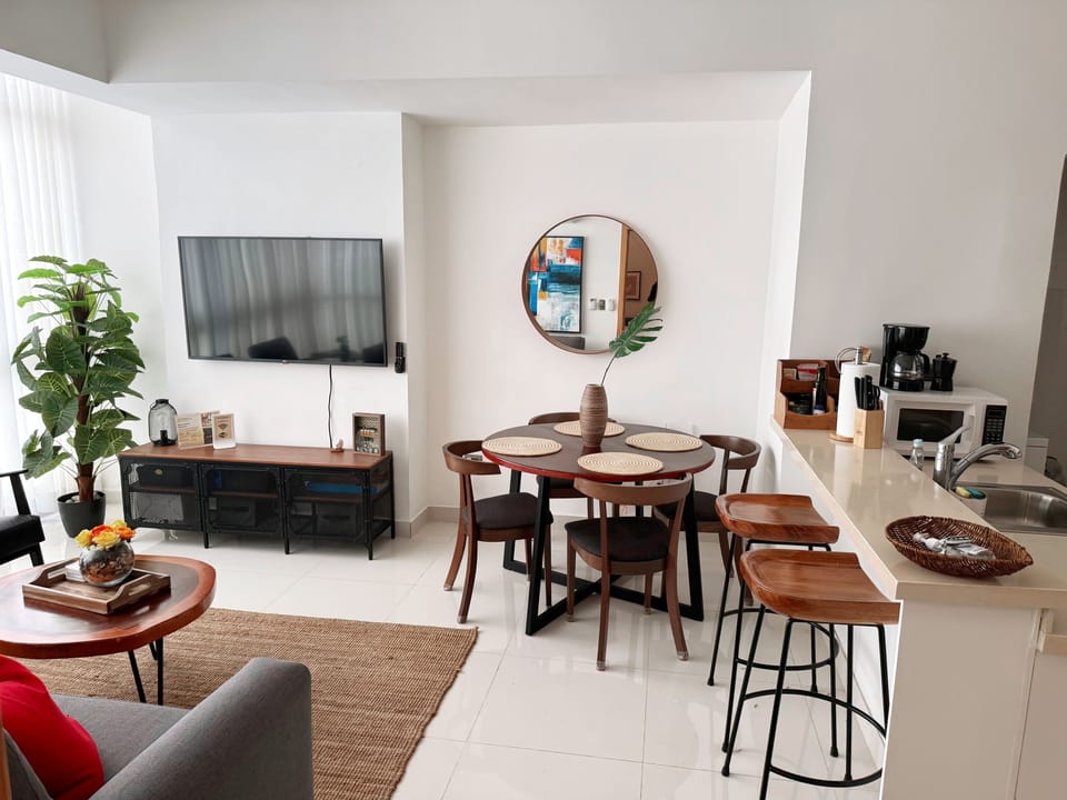 dinning area, with two stools and a dinning table with 4 chairs