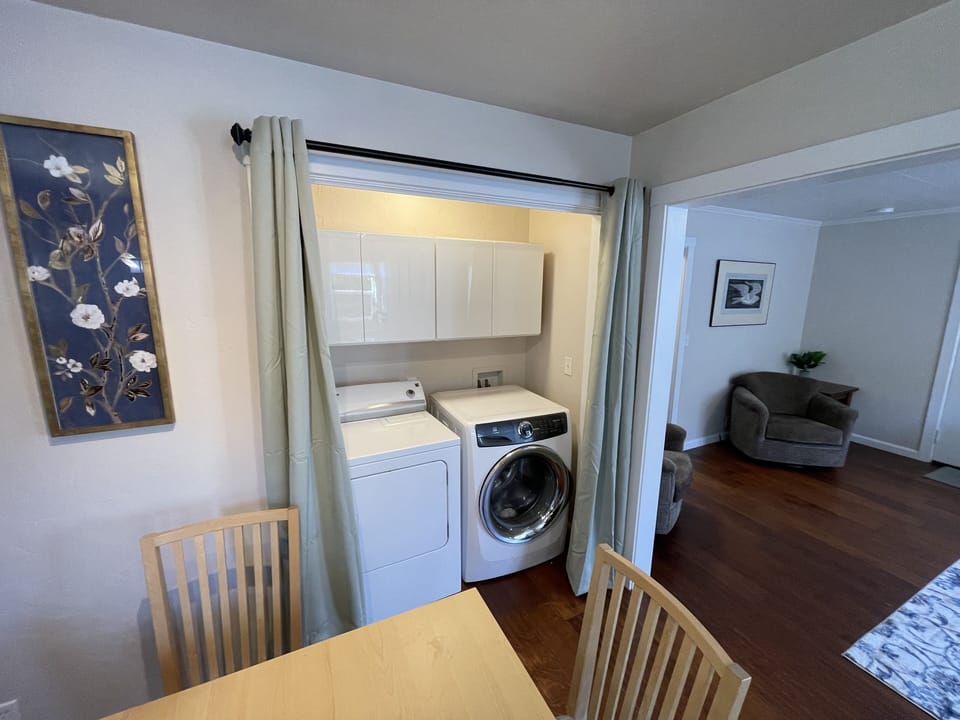 Washer and dryer with complimentary supplies.