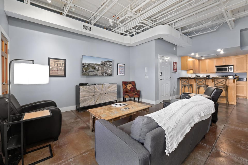 Spacious living room with cozy seating and modern kitchen access