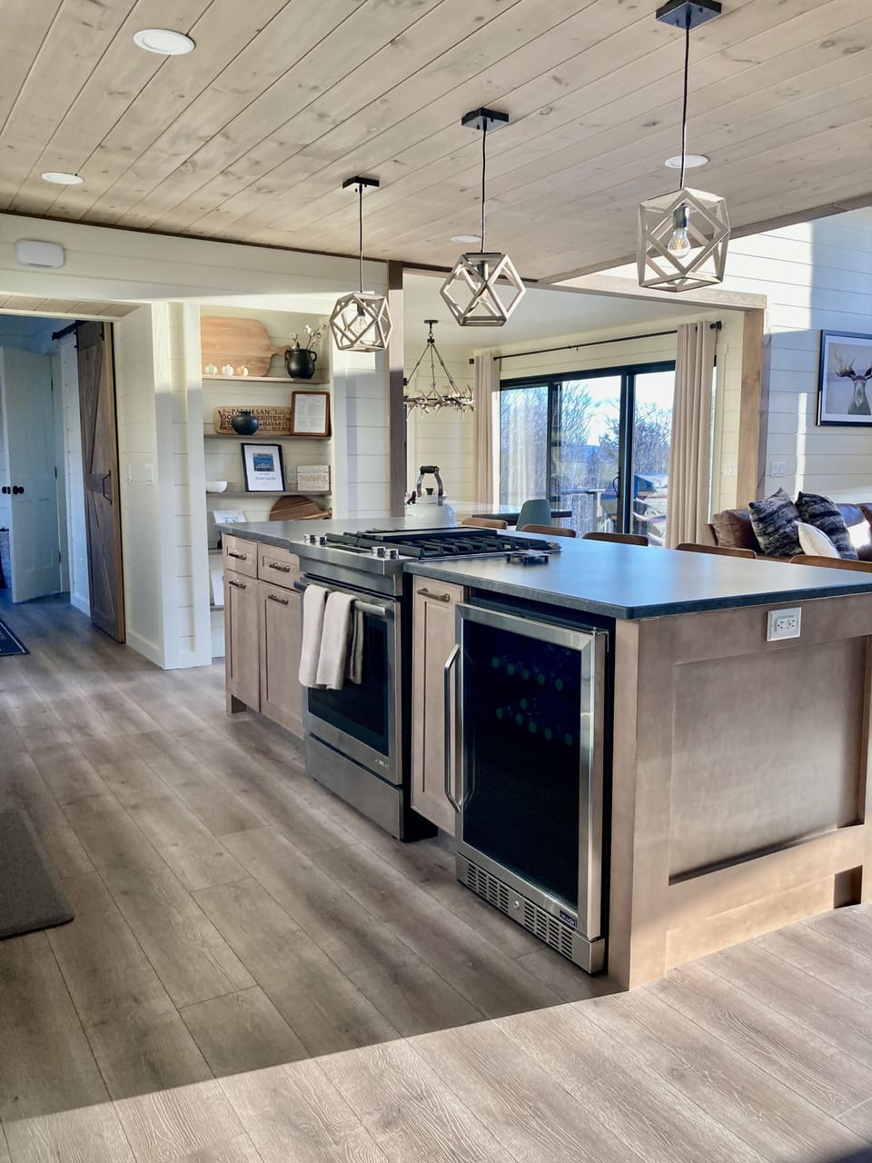 Island with built in gas range stove and mini fridge. 