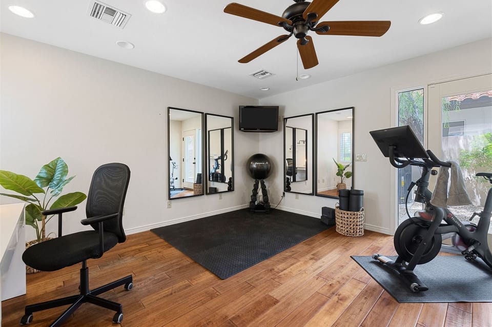 Separate, private office and gym with Peloton, free weights, yoga mats and TV.
