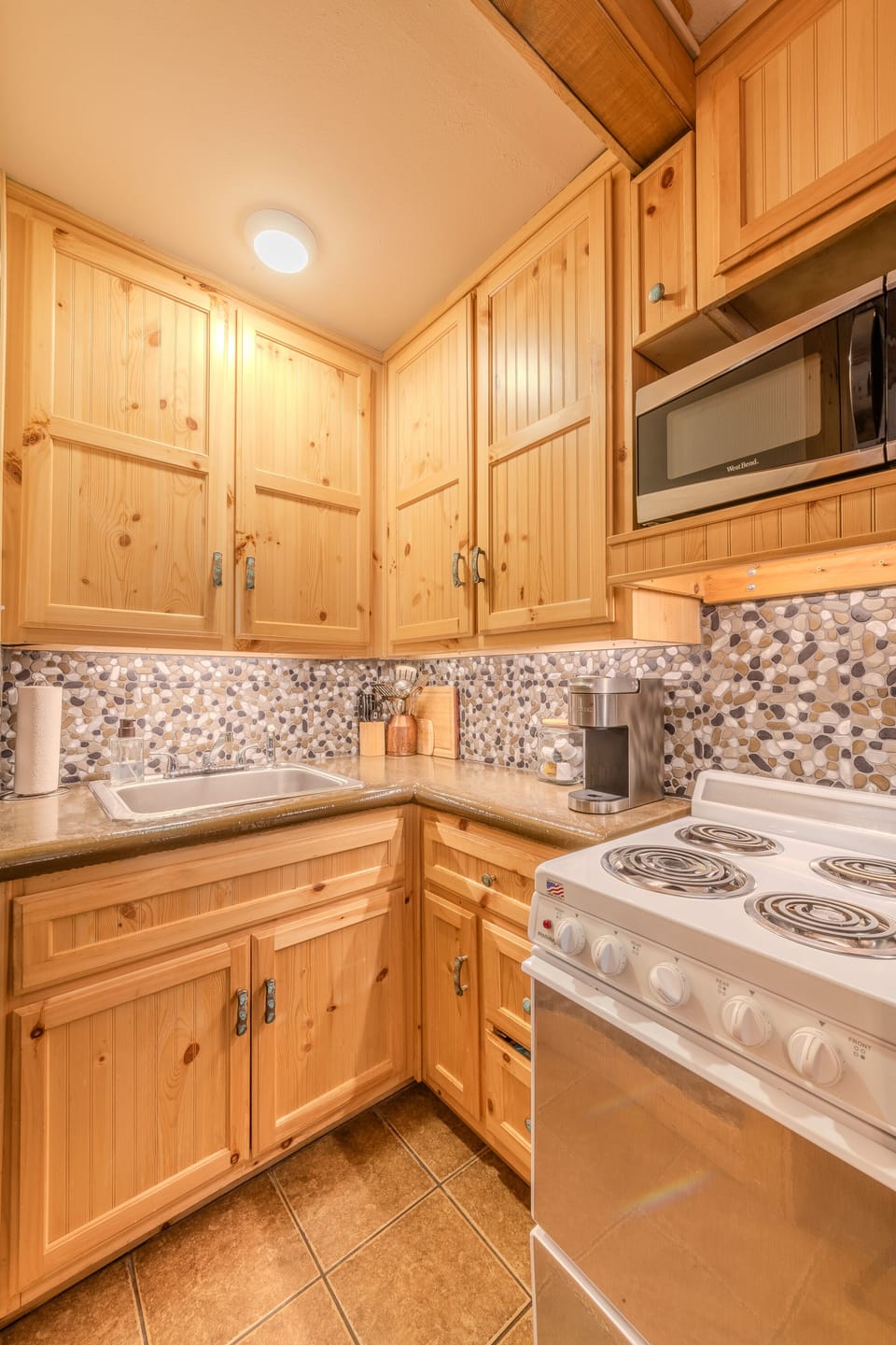 Fully stocked kitchen with 4 burner stove and oven. Full sized refrigerator. 