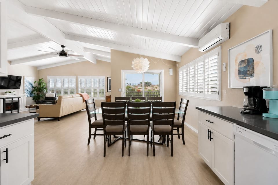 Fireside Comfort: Enjoy Plush Chairs by the Fireplace with Easy Access to the Open Dining Space.