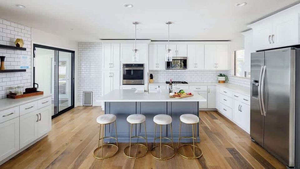 Fully equipped kitchen with stainless steel appliances, coffee bar, breakfast bar seating, and filled with basic cooking essentials.