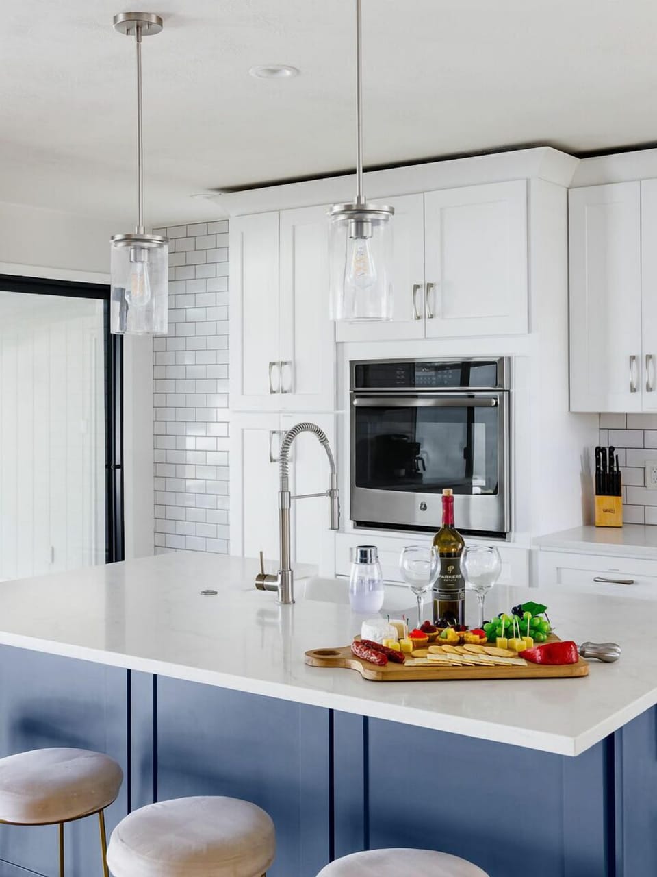 Fully equipped kitchen with stainless steel appliances, coffee bar, breakfast bar seating, and filled with basic cooking essentials.