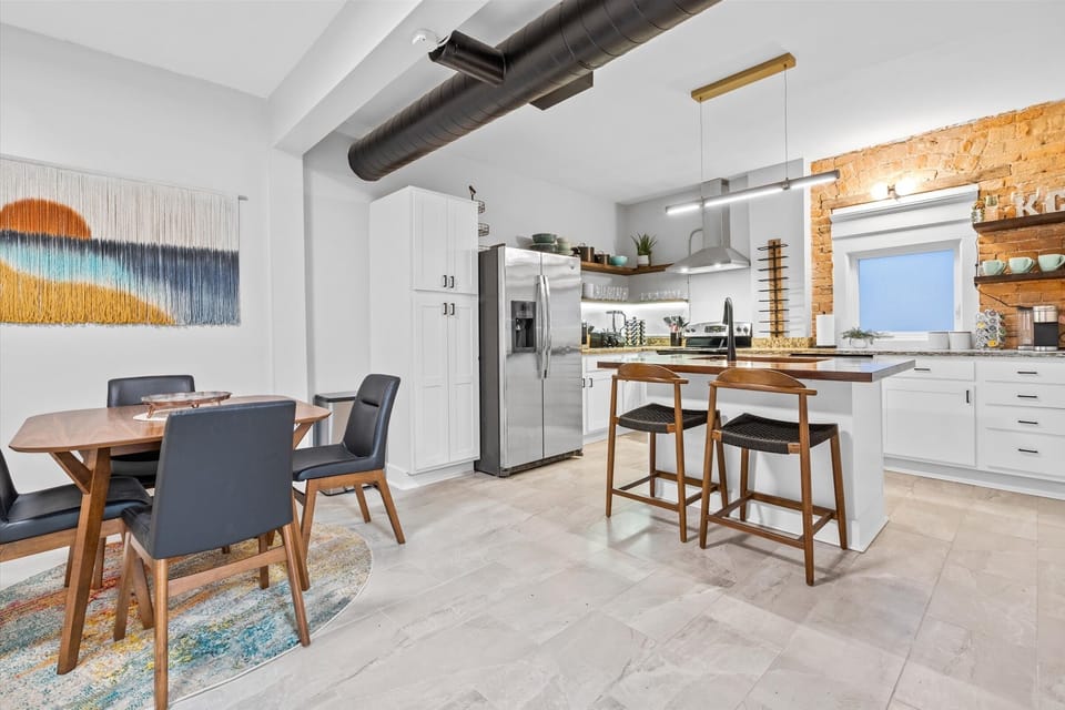 Remodeled kitchen features bar seating and an eat-in table for four