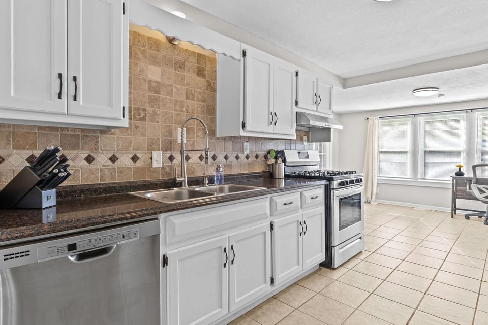 Fully equipped kitchen with stainless steel appliances, spacious countertops, and ample cabinet storage—great for preparing meals during your Kansas City stay.