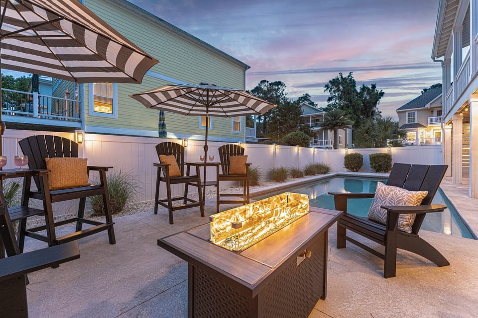 Gorgeous outdoor area with ample seating, fire pit table, pool and hot tub