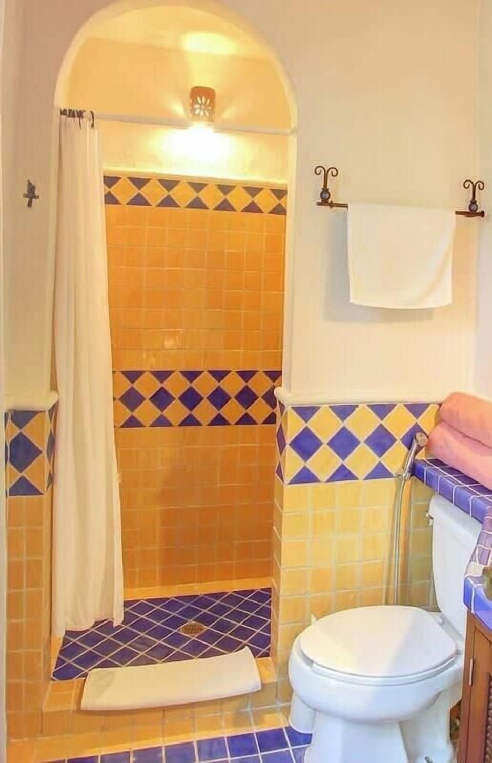 Bright, colorful tiles add a touch of charm to bathroom 1.
