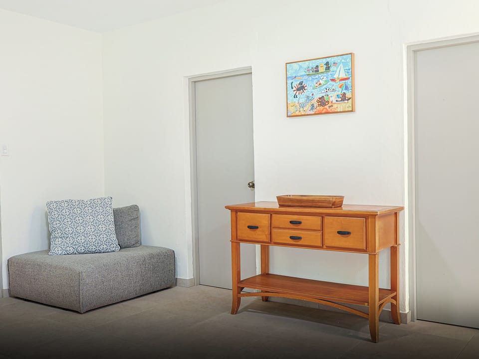Secondary living area, equipped with recliner and corner lounge chair.