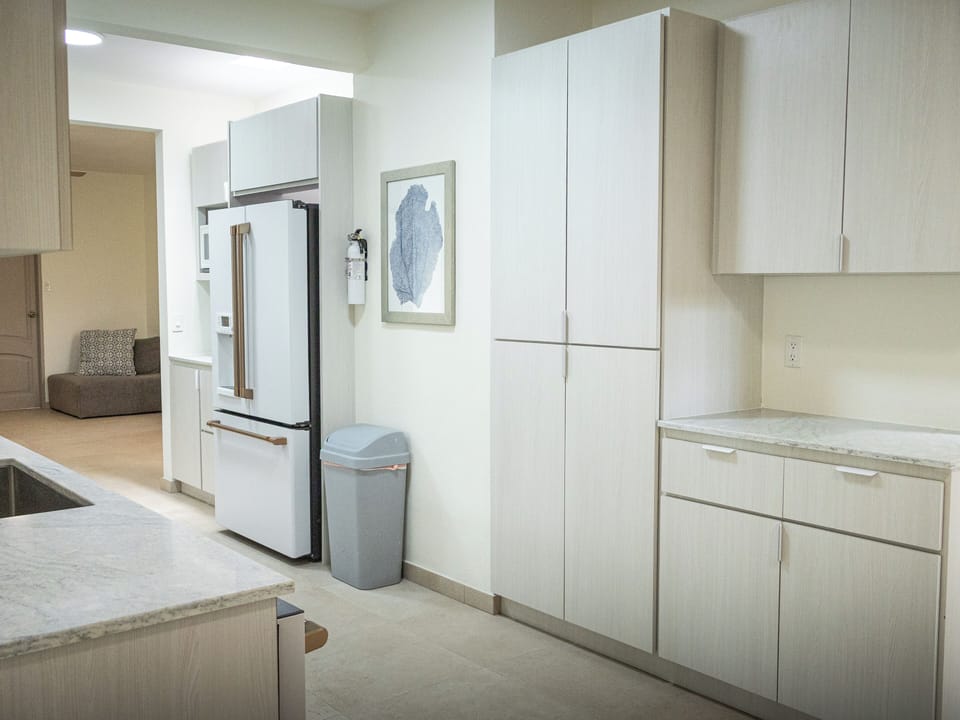 Galley kitchen runs through the middle of the house.