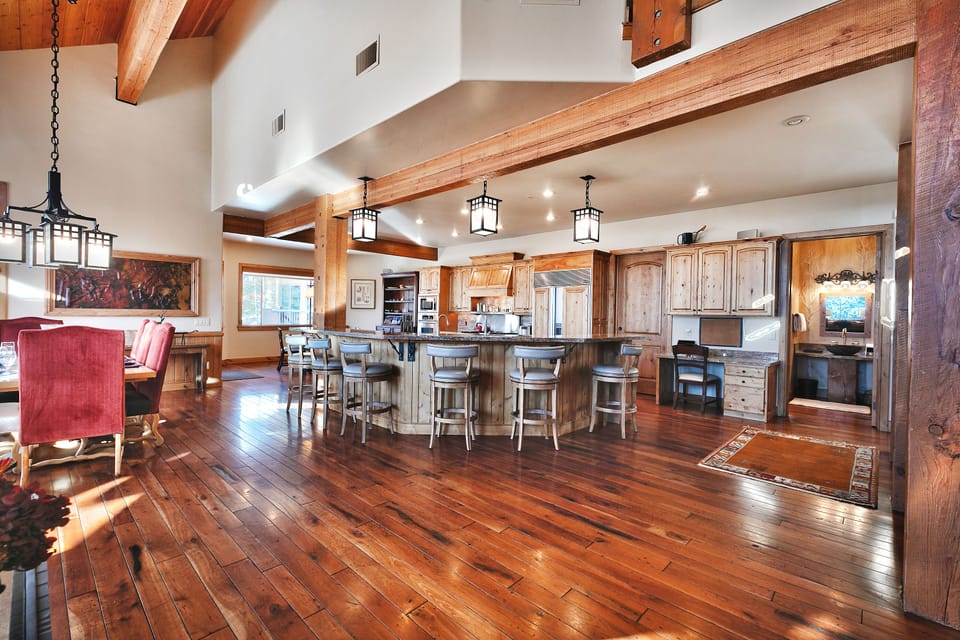 The kitchen has a spacious open floor plan, a wrap around island with seating for 6 on leather and wood barstools.