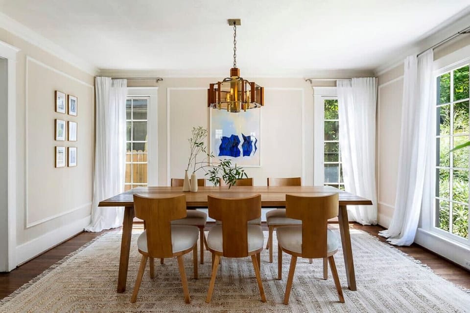 Elegant dining setup—wooden table with matching chairs for a warm and inviting mealtime experience.