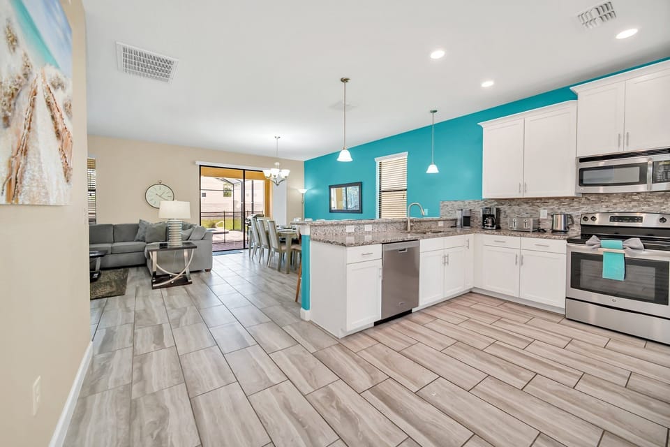 Modern, fully equipped kitchen and dining area, designed with an open layout for easy meal prep.