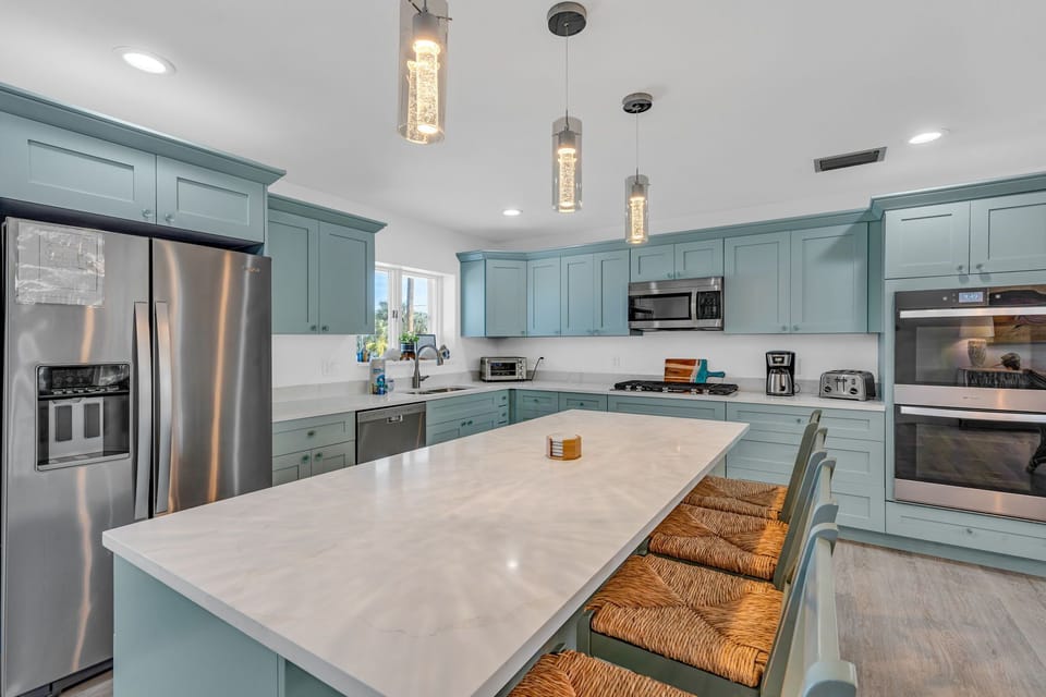 Kitchen Island with high chairs and fridge