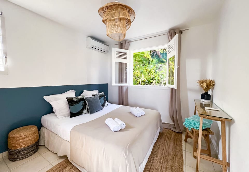Bedroom with window overlooking the back of the house